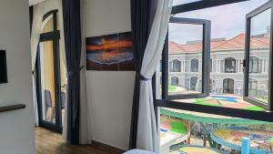 a room with a window and a view of a building at The Star hotel DTH3-31 in Phú Quốc