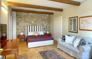 a bedroom with a bed and a couch at Az Ag Ricciarelli N in San Giuliano di Puglia