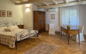 a bedroom with a bed and a table and a desk at Az Ag Ricciarelli N in San Giuliano di Puglia