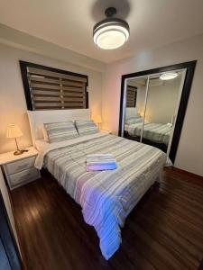a bedroom with a large bed with a large mirror at Millenium Star in Mendoza +2 photos