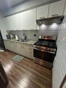 a kitchen with a stove and a sink at Millenium Star in Mendoza