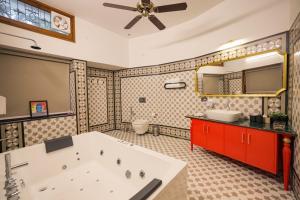 a large bathroom with a tub and a mirror at The Mars Sphere in Dehradun +101 photos