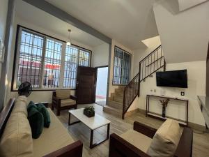 a living room with a couch and a fireplace at 8 habitaciones para 16 personas in Flores