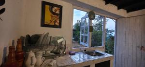 a kitchen with a sink and a window at Kithul Cottage 2 in Watagoda