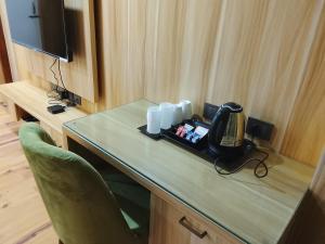 a desk in a room with a phone on it at Pines Dirang Homestay in Chug