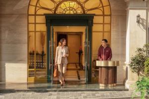 a man and a woman standing outside of a building at Sapa Horizon Hotel & Skybar in Sapa