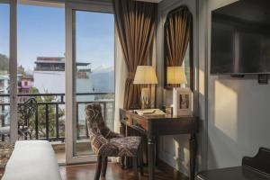 a bedroom with a desk and a window with a view at Sapa Horizon Hotel & Skybar in Sapa