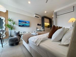 a bedroom with a large bed with a teddy bear on it at Le Arch Suite - Georgetown Komtar View Studio in George Town +31 photos