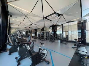 a gym with a lot of treadmills and exercise bikes at Le Arch Suite - Georgetown Komtar View Studio in George Town