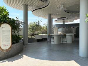 a patio with tables and chairs under a roof at Le Arch Suite - Georgetown Komtar View Studio in George Town
