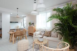 a living room with a couch and a table at Pine & Cedar Suites – Hua Xiao Ye in Shanghai