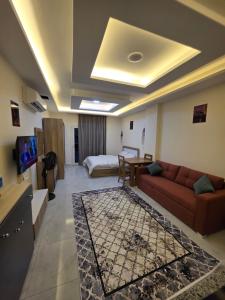a living room with a couch and a bed at Jemmy Home in Sharm El Sheikh