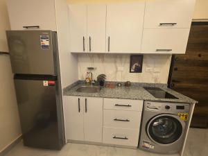a kitchen with a refrigerator and a washing machine at Jemmy Home in Sharm El Sheikh