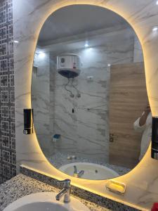a person taking a picture of a bathroom mirror at Jemmy Home in Sharm El Sheikh