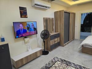 a bedroom with a flat screen tv on the wall at Jemmy Home in Sharm El Sheikh +4 photos