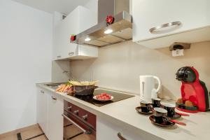 a kitchen with a counter top with a red appliance at Clementines 50 Meters From Sea - Happy Rentals in Roquebrune-Cap-Martin