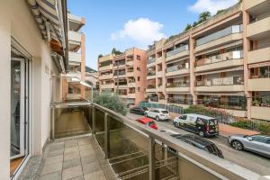 an apartment balcony with a view of a parking lot at Clementines 50 Meters From Sea - Happy Rentals in Roquebrune-Cap-Martin +16 photos