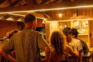 a group of people standing around a bar at Sun & Roots Kampot Lodge in Kampot +54 photos