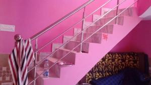 a staircase with pink walls and an american flag at Home in Lucknow