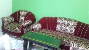 a living room with a couch and a table at Home in Lucknow