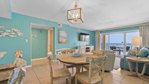 a dining room and living room with a table and chairs at Beachfront Bliss in Gulf Shores