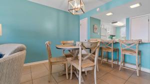 a dining room with a table and chairs at Beachfront Bliss in Gulf Shores