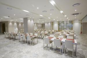 a banquet hall with tables and chairs in a room at Royal Emporium Incheon Airport in Incheon
