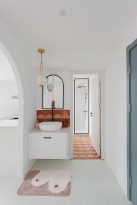 a white bathroom with a sink and a mirror at Pine & Cedar Suites – Hua Xiao Ye in Shanghai +283 photos