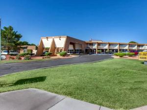 a building with a green lawn in front of a building at Scenic View Inn - Lake Powell - Page AZ in Page