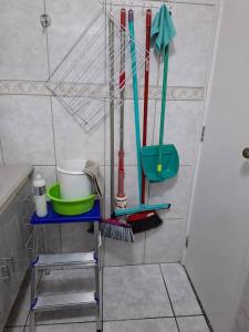 a bathroom with a rack with cleaning tools on it at Espaço Van Gogh Poços de Caldas in Poços de Caldas +30 photos