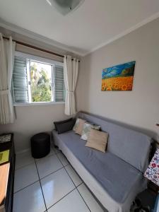 a living room with a couch and a window at Espaço Van Gogh Poços de Caldas in Poços de Caldas