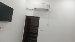 a toaster sitting on top of a white wall at Hotel Royal galaxy in Dharāsu