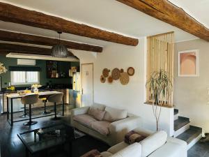 a living room with a couch and a table at Villa Sainte Anne in Sénas