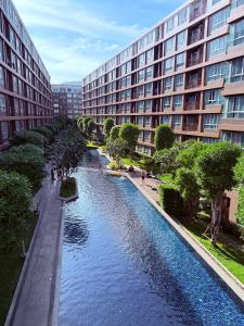a river in front of a large building at Calm Home in Phuket