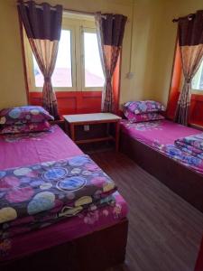 a room with two beds and a window at Mountain View Lodge - 1 Minute from Lukla Airport in Lukla +50 photos