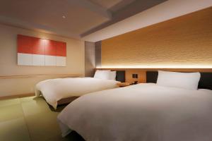 a hotel room with two beds at 游水亭いさごや in Tsuruoka +59 photos