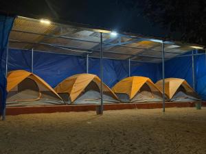 a row of tents in a blue and white structure at Beach vibe in Udupi +20 photos