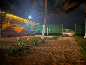 a house with a painting on the side of it at night at Beach vibe in Udupi
