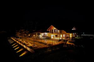 a house at night with lights in front of it at Akruthi Palm Pavilion Resort in Aldūr