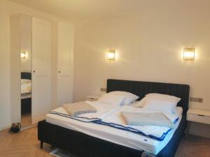 a bed in a room with two pillows on it at Gemütlich & stilvoll in Tuchola