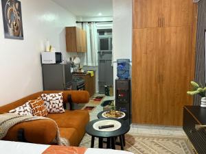 a living room with a couch and a kitchen at Membley star heights -Naivera in Ruiru