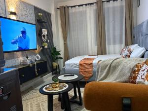 a bedroom with a bed and a tv in a room at Membley star heights -Naivera in Ruiru