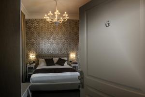 a bedroom with a large bed and a chandelier at Villa San Martino in Naples