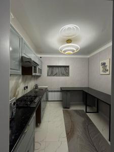 a kitchen with a stove and a counter top at Villa De Ray in Almaty