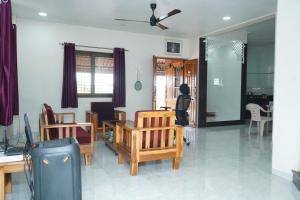 a living room with a person standing in the living room at Sattva Gruha in Māngaon