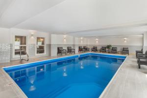 a swimming pool with blue water in a building at Velora Hinton, an Ascend Collection Hotel in Hinton