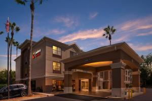 a hotel with a car parked in front of it at Comfort Suites Tallahassee Capitol - University Area in Tallahassee