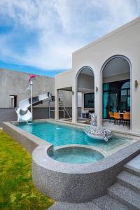 a swimming pool in the backyard of a house at นารา พลูวิลล่า in Cha Am