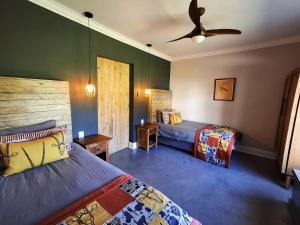 a bedroom with two beds and a ceiling fan at SoetHoek Farm Retreat in Alexandria +41 photos