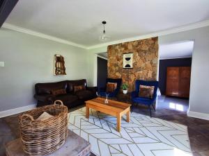a living room with a couch and a table at SoetHoek Farm Retreat in Alexandria